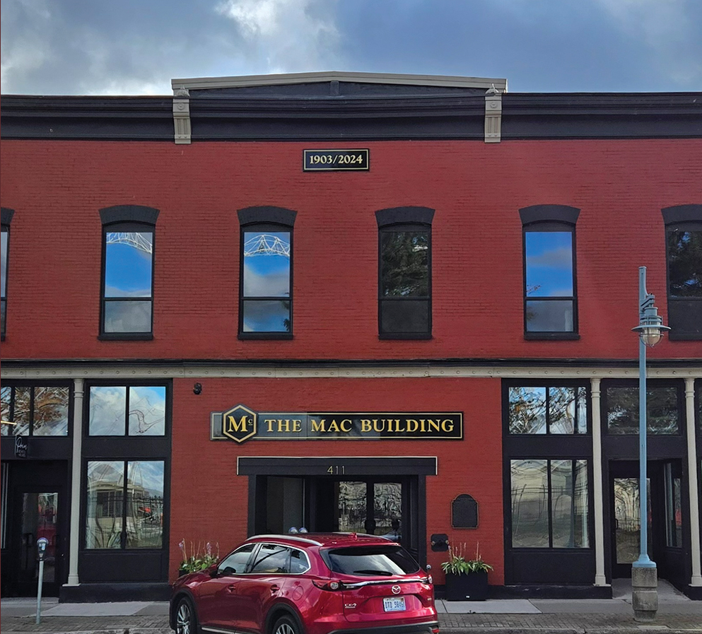 The restored red brick facade of The Mac Building on Portage Avenue