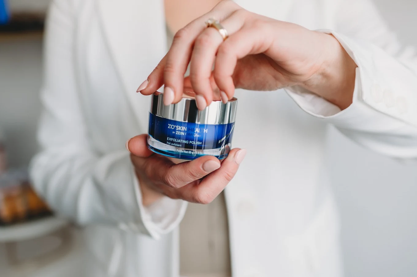 Skincare product held by a Prim practitioner